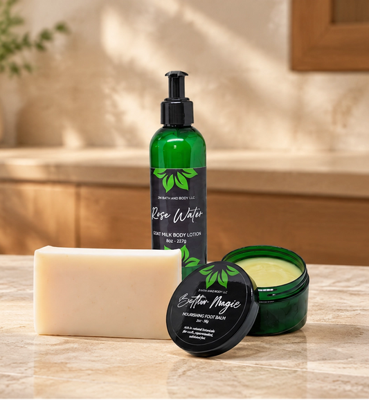 A set of three botanical skincare products from the brand 'Botanical Beauty' arranged on a marble countertop in a warm, sunlit bathroom setting. The products include a green pump bottle of body wash, a green jar of body butter with its lid off, and a solid bar of soap.